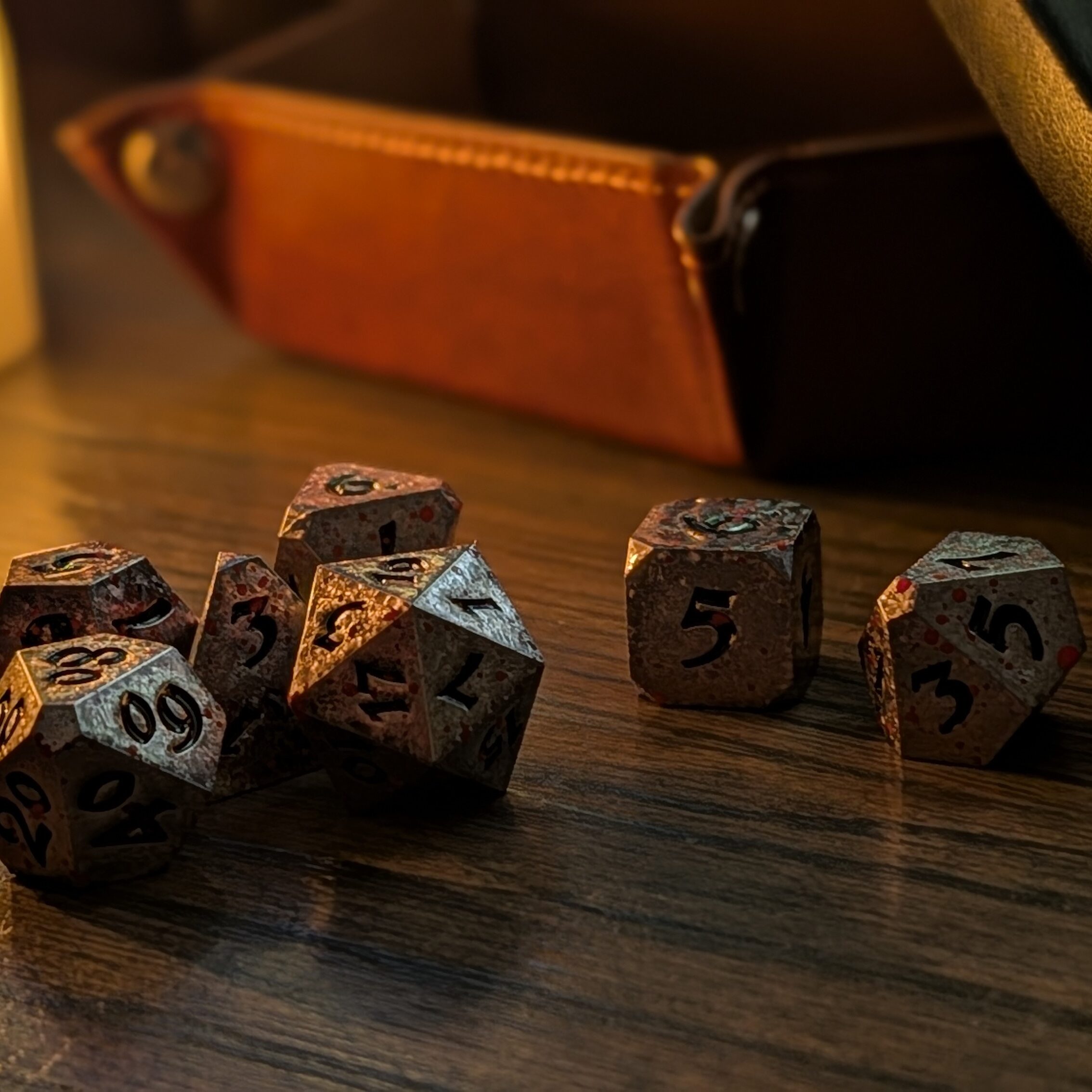 Hero photo of Die Hard Dice Bloody Starrazor set on wooden table with dramatic side light.